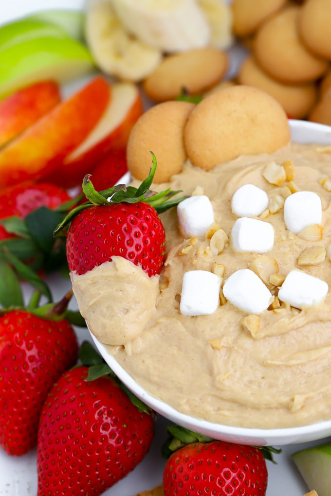 Fluffernutter Dip topped with marshmallows and a strawberry.