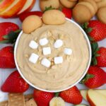 A bowl of Fluffernutter dip with fruit and vanilla wafer cookies