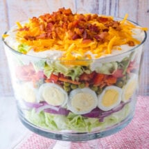 7 Layer Salad is a classic potluck dish great for feeding a crowd. These layers of deliciousness can be made ahead of time for these easiest side dish ever!