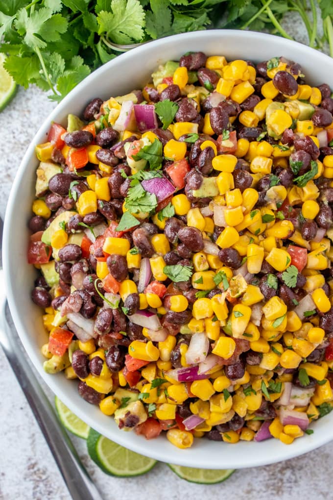 an overhead image of a large bowl filled with corn and black bean salad
