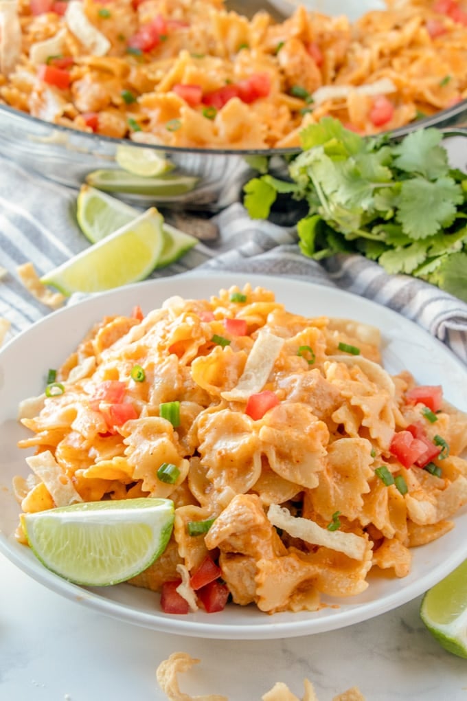 a plate of chicken taco pasta with fresh limes