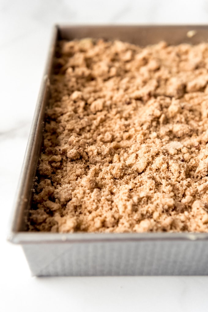 An image of cinnamon crumb cake in a pan.