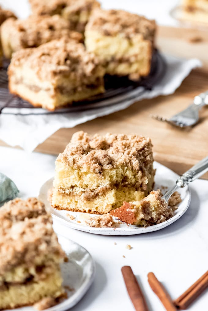 An image of a slice of moist coffee cake with cinnamon streusel.