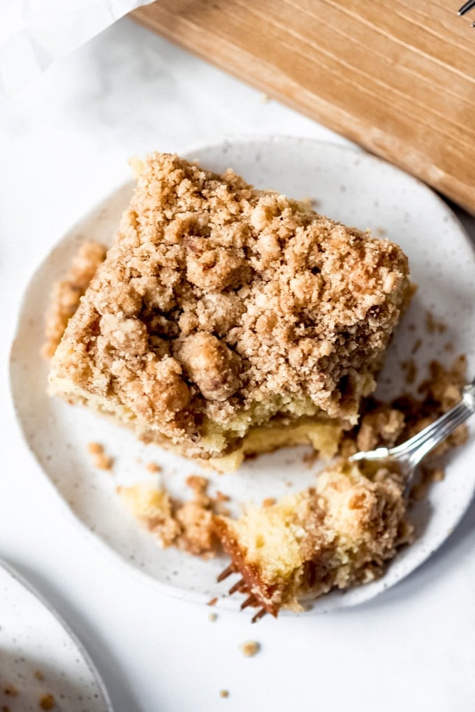 An image of a piece of sour cream coffee cake on a plate.