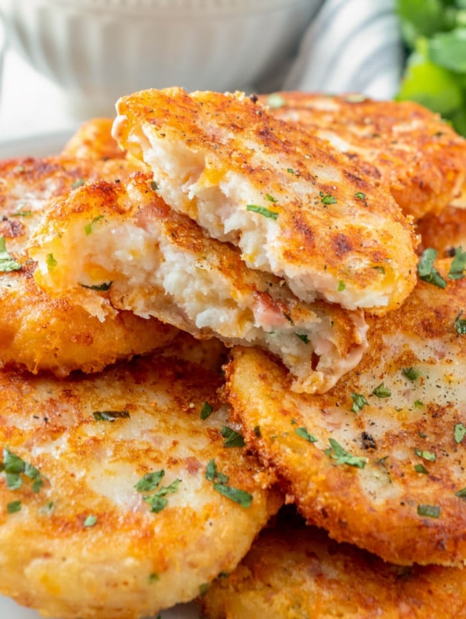 a stack of potato croquettes with one broken in half on top