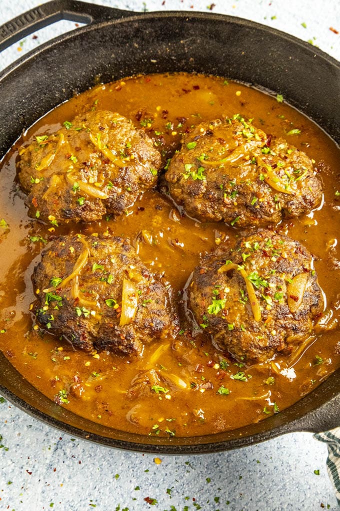 Salisbury Steaks simmering in a pan