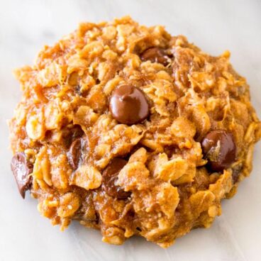 A cookie filled with oats and chocolate chips.