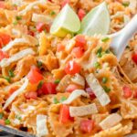 A bowl of taco pasta with chicken and tomato