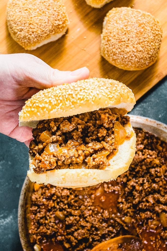 Sloppy Joe sandwich held in hand.