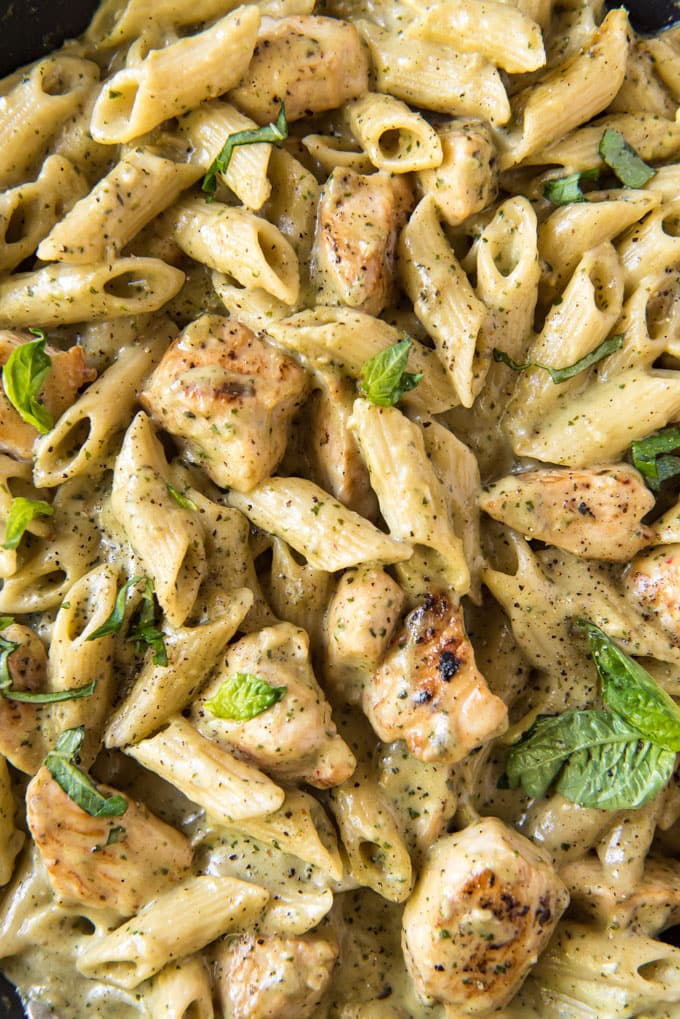 A close up of pasta and chicken with creamy pesto sauce