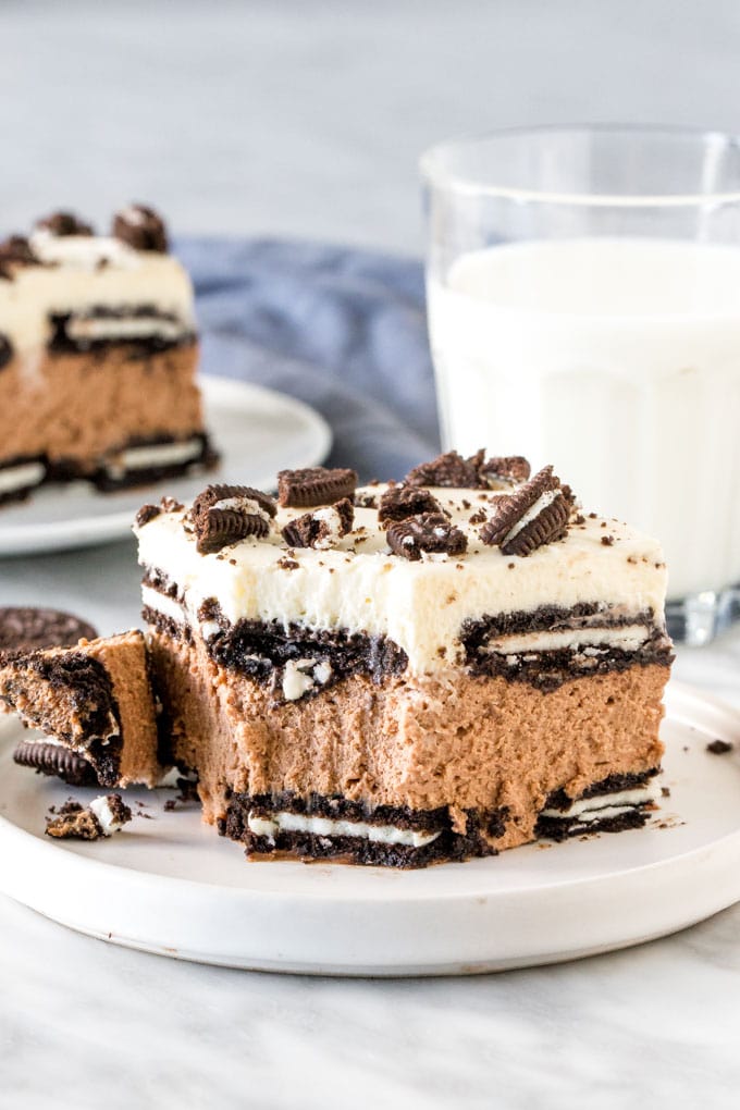 Slice of Oreo Icebox cake with a bite taken out of it. 