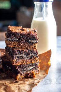 slutty brownies stacked with a milk bottle beside