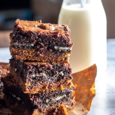 slutty brownies stacked with a milk bottle beside