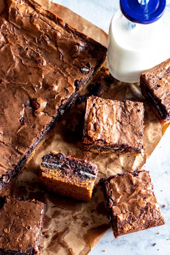 slutty brownies on brown paper with milk bottle