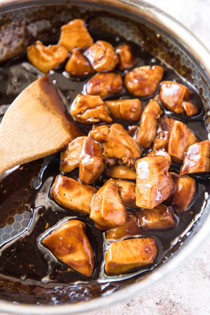 a skillet with chicken chunks in teriyaki sauce