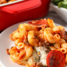 pizza casserole with pepperoni on a white plate