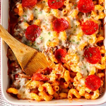 A close up of pasta with cheese and pepperoni,