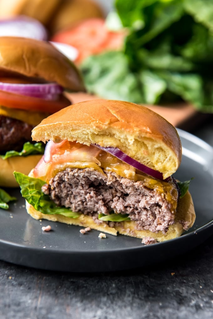 A cheeseburger cut in half, exposing the center of the meat and bun