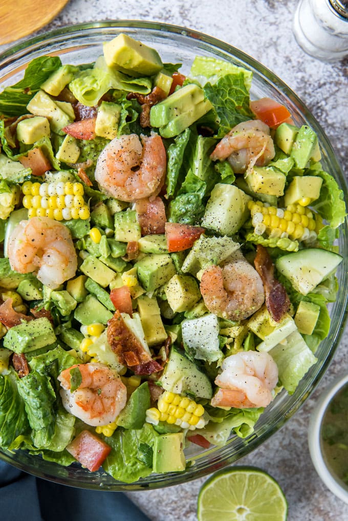 salad with shrimp, avocado, corn in a glass bowl