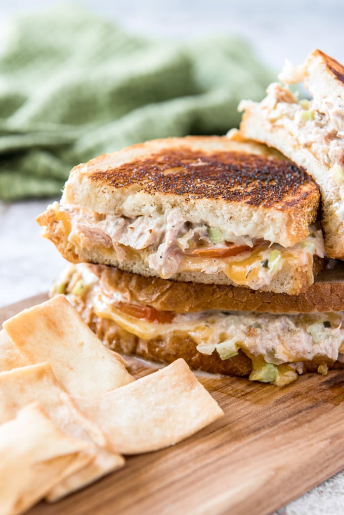 A Tuna Melt is a classic hot grilled sandwich, with flavorful tuna fish salad, fresh sliced tomatoes and melted cheddar cheese all served on toasted bread.