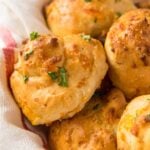 A close up of homemade bread rolls with garlic and cheese.