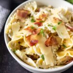 bowtie pasta, cream sauce bacon, white bowl