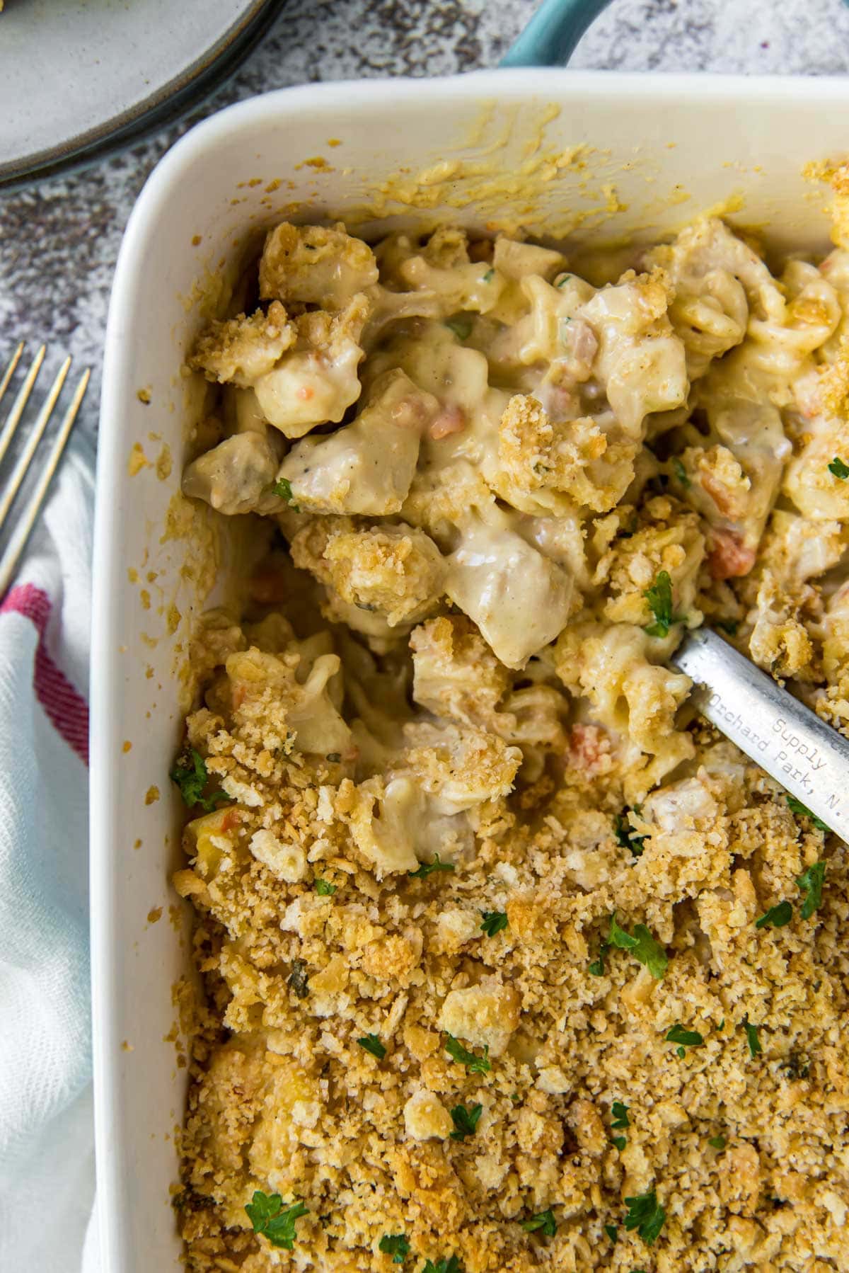 casserole dish with spoon and chicken pasta cream sauce casserole