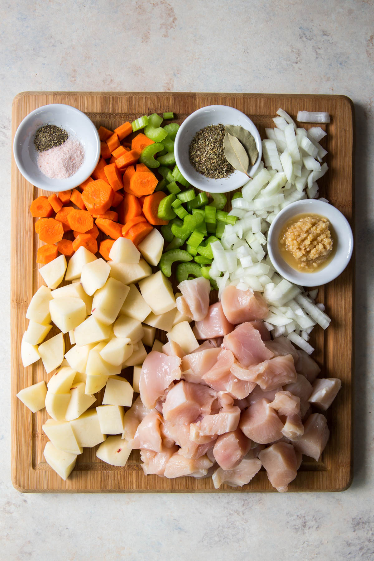 ingredients for chicken stew on a cutting board
