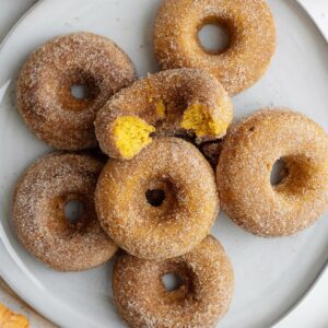 pumpkin donuts on a white platter