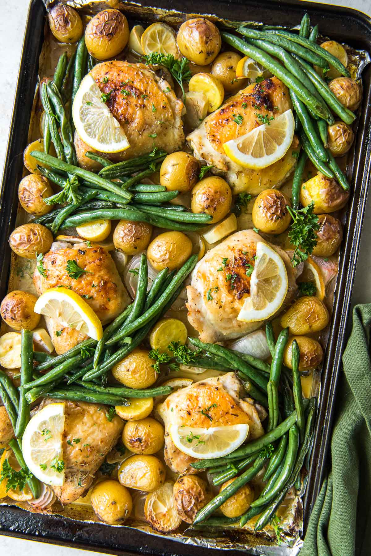 large sheet pan chicken, potatoes, green beans, lemons, garlic, onions