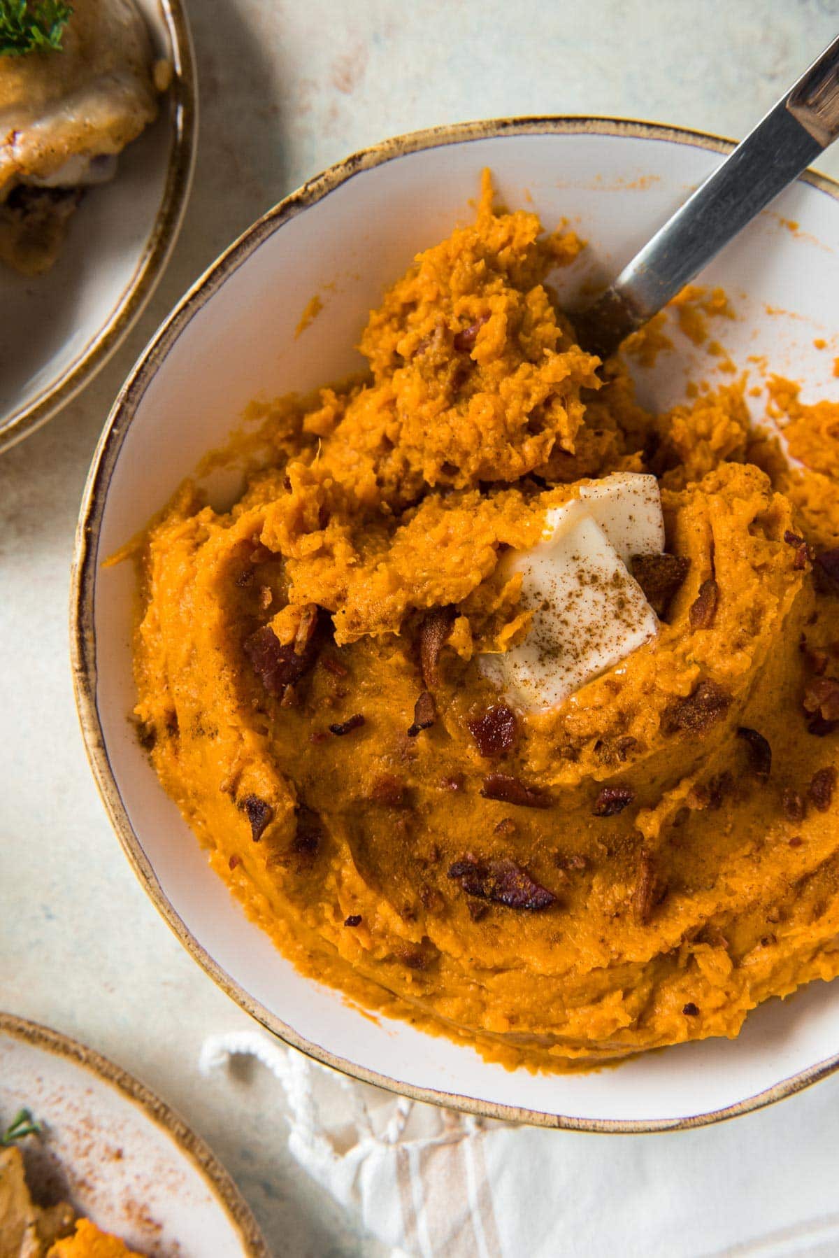 white bowl, mashed sweet potatoes, spoon