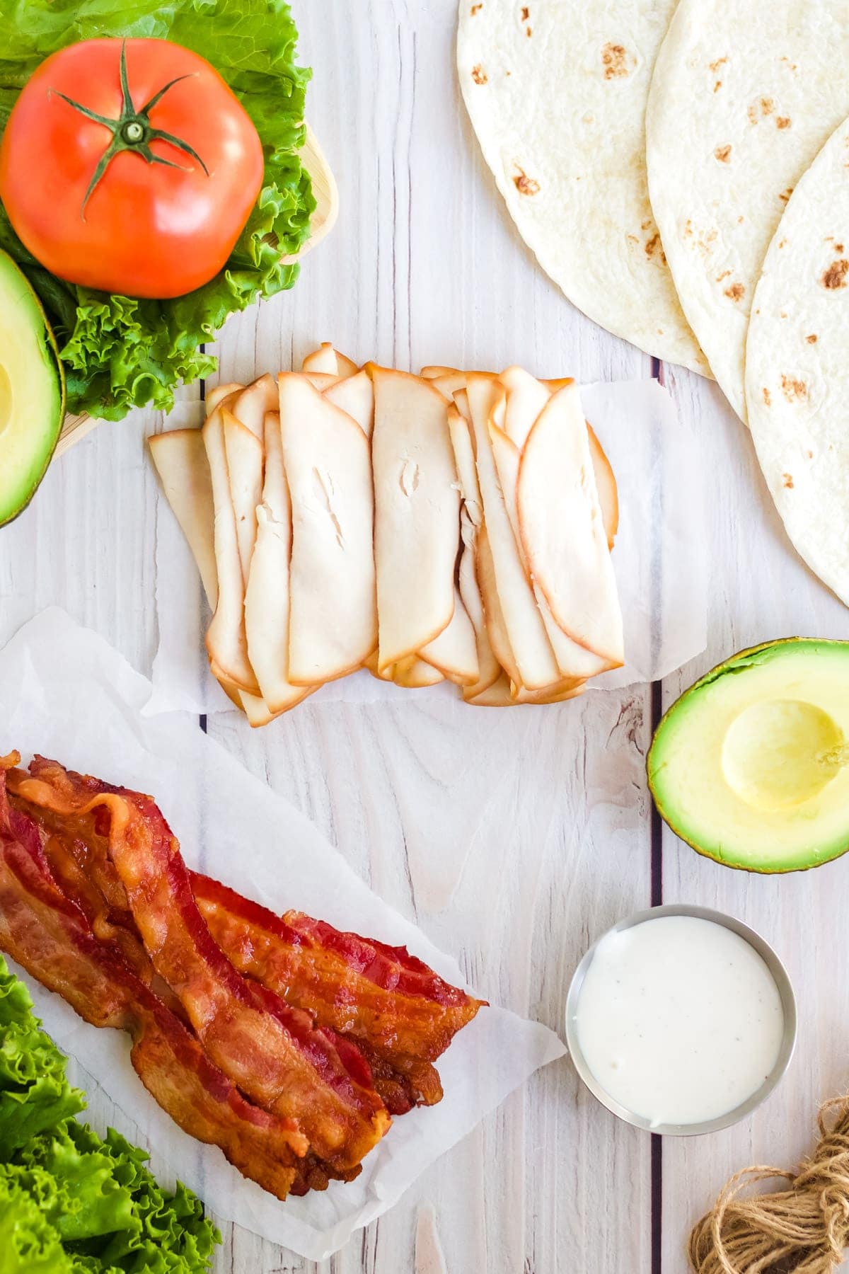 Ingredients to make turkey BLT wraps. 