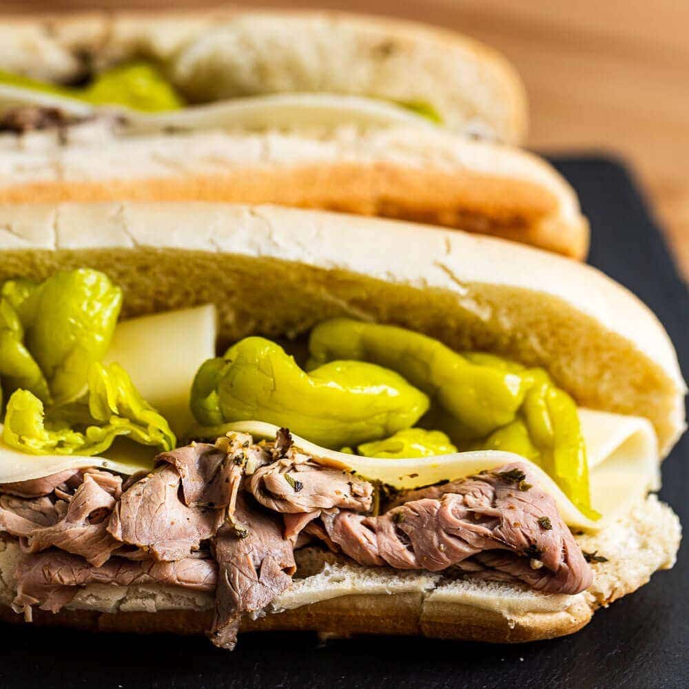 Italian beef sandwich on black slate board.