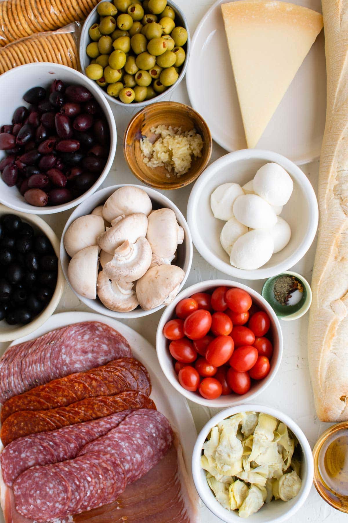 Salami, cheese, tomatoes, olives, mushrooms, bread, artichokes