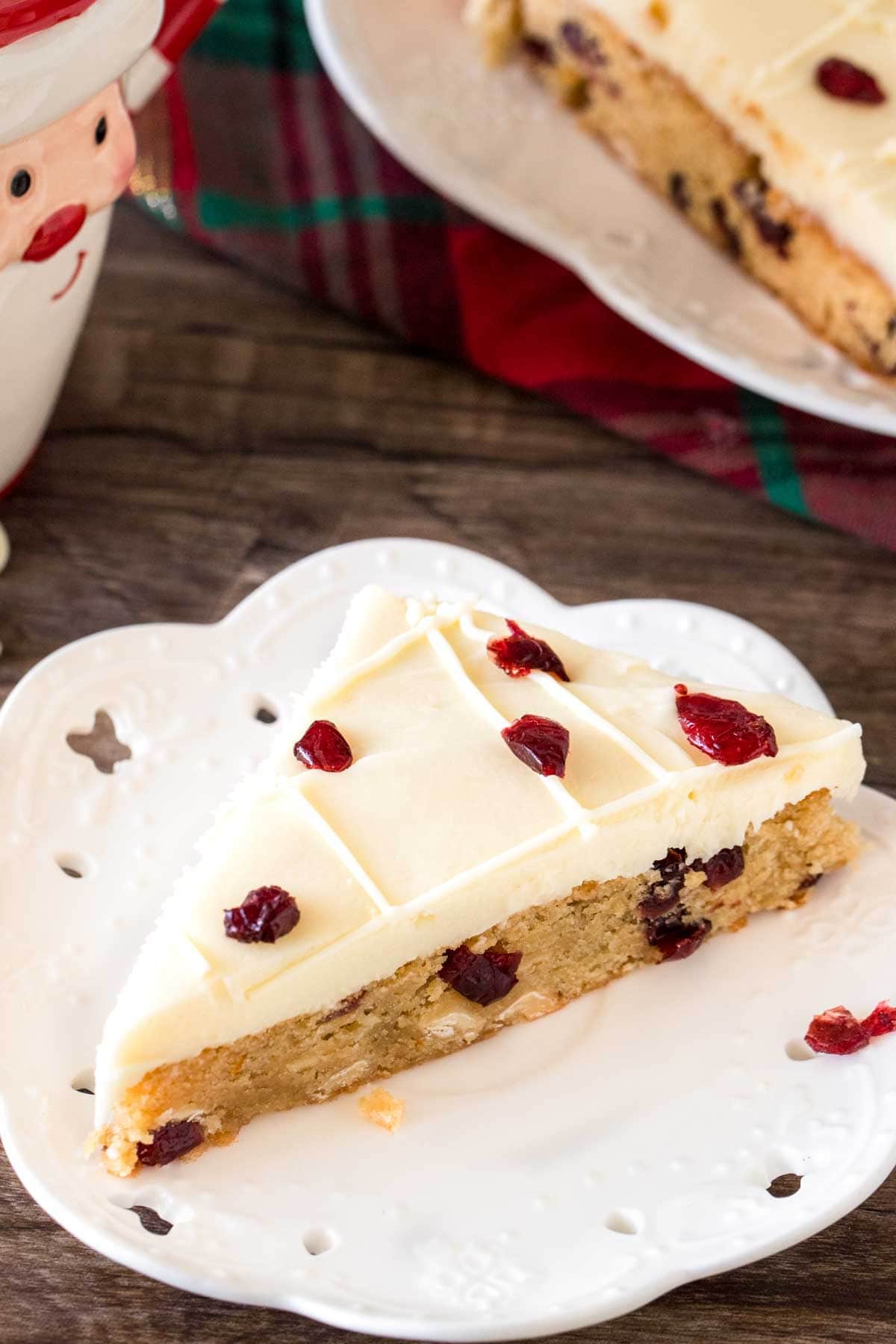 Slice of homemade cranberry bliss bar on a plate. 