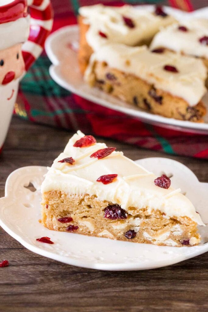 Slice of cranberry bar with cream cheese frosting