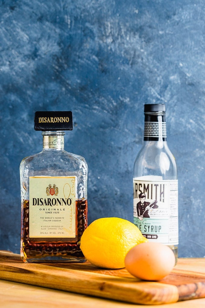 Ingredients shown: Amaretto, simple syrup, lemon, and egg.