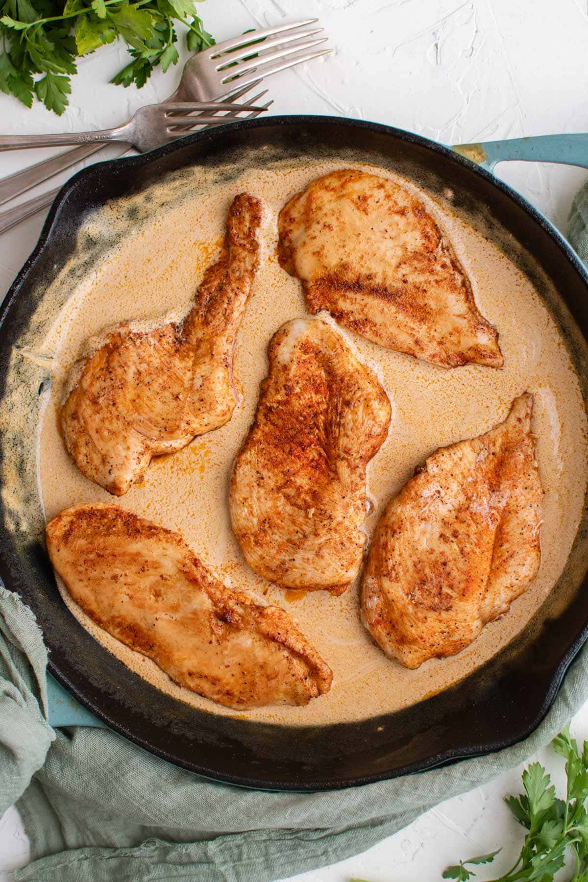 black skillet with chicken breasts in mustard sauce