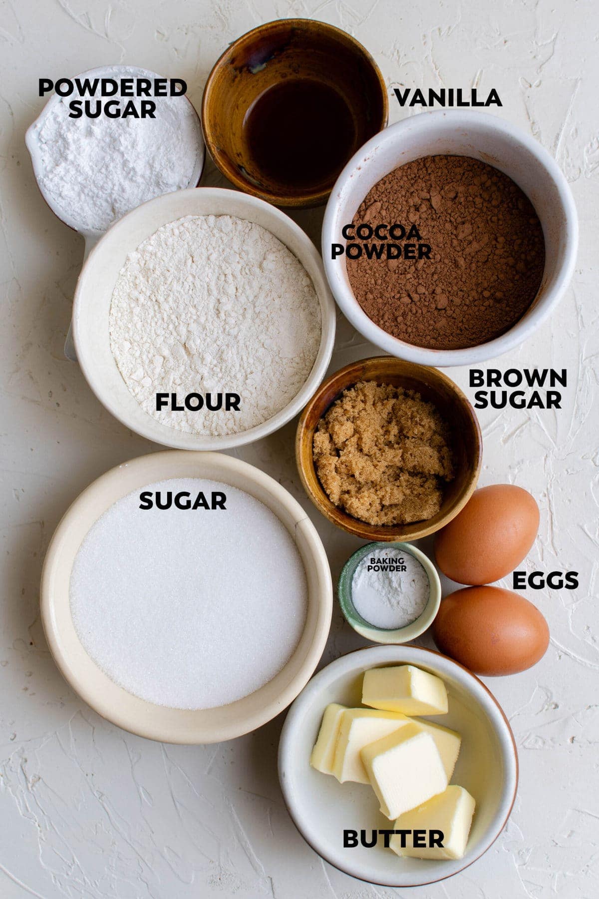 ingredients in bowls for making chocolate crinkle cookies