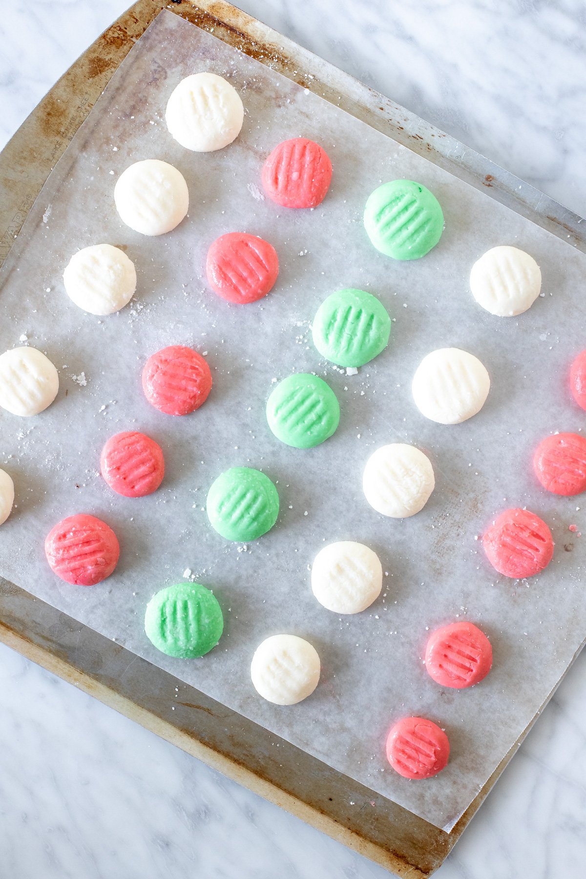 Cookie sheet of cream cheese candies. 