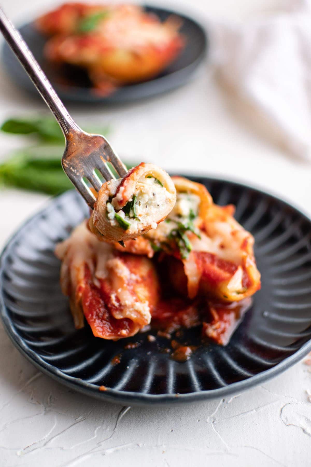 stuffed shells with cheese, red sauce, fork