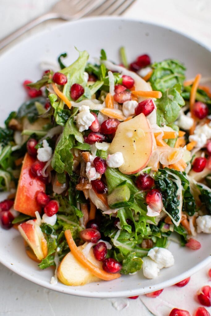 Lettuce and kale salad with apples and pomegranate seeds