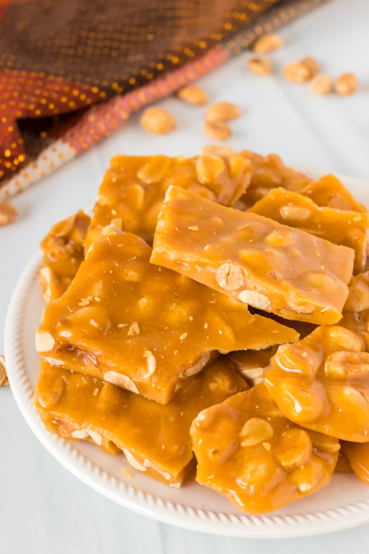 white plate of peanut brittle