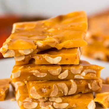 stack of peanut brittle on a white plate