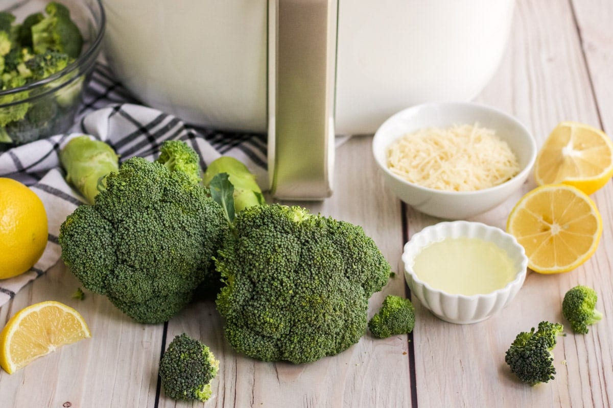 broccoli, air fryer, parmesan cheese, lemons, olive oil, blue and white napkin