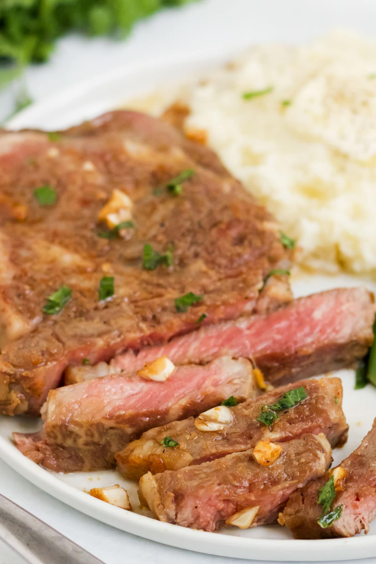 sliced medium rare steak, potatoes