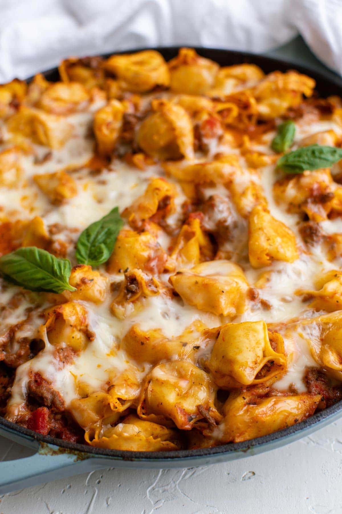 black skillet, tortellini in meat sauce with cheese