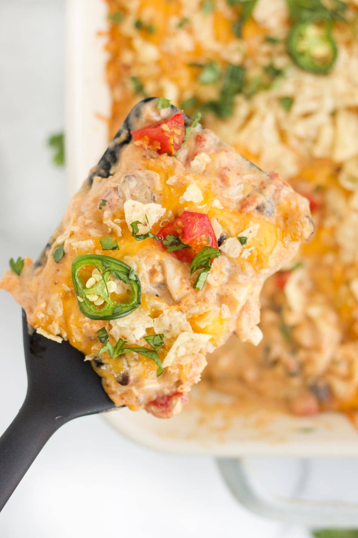 An overhead image of a scoop of chicken taco casserole. 