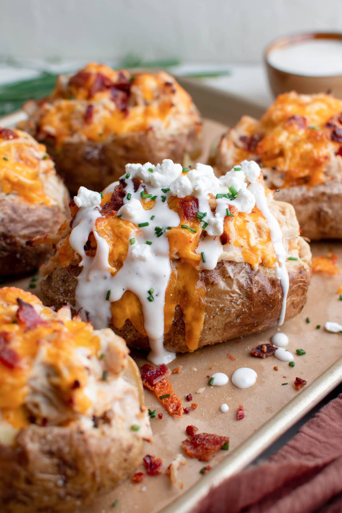 baked potatoes with cremay chicken, cheese, bacon and ranch, baking sheet and parchment paper