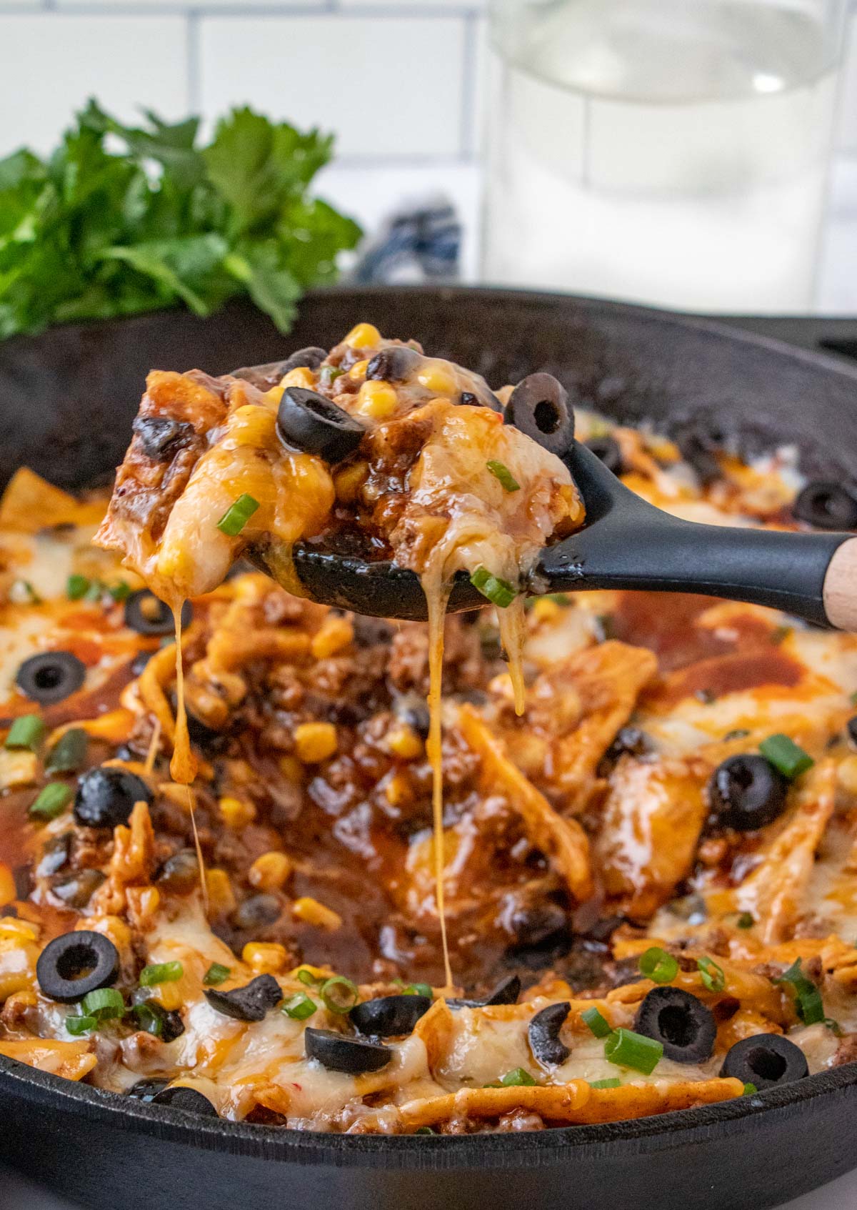 enchilada skillet, cast iron skillet, olives, black spoon